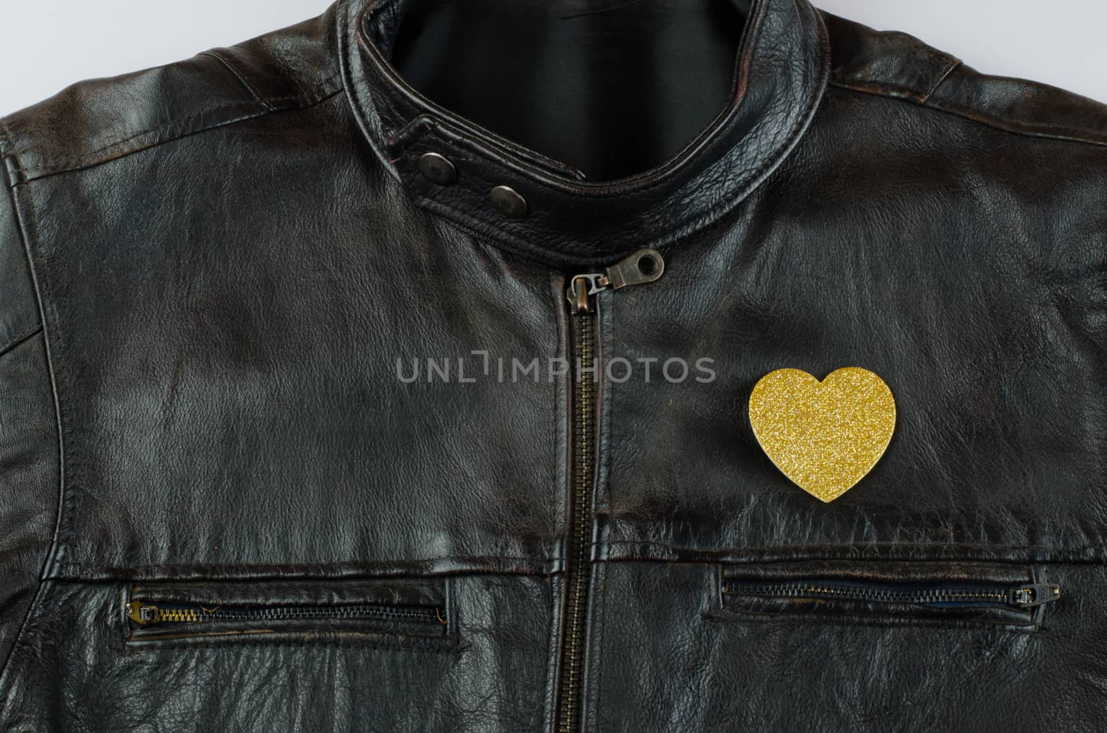 Heart of gold on old black leather jacket