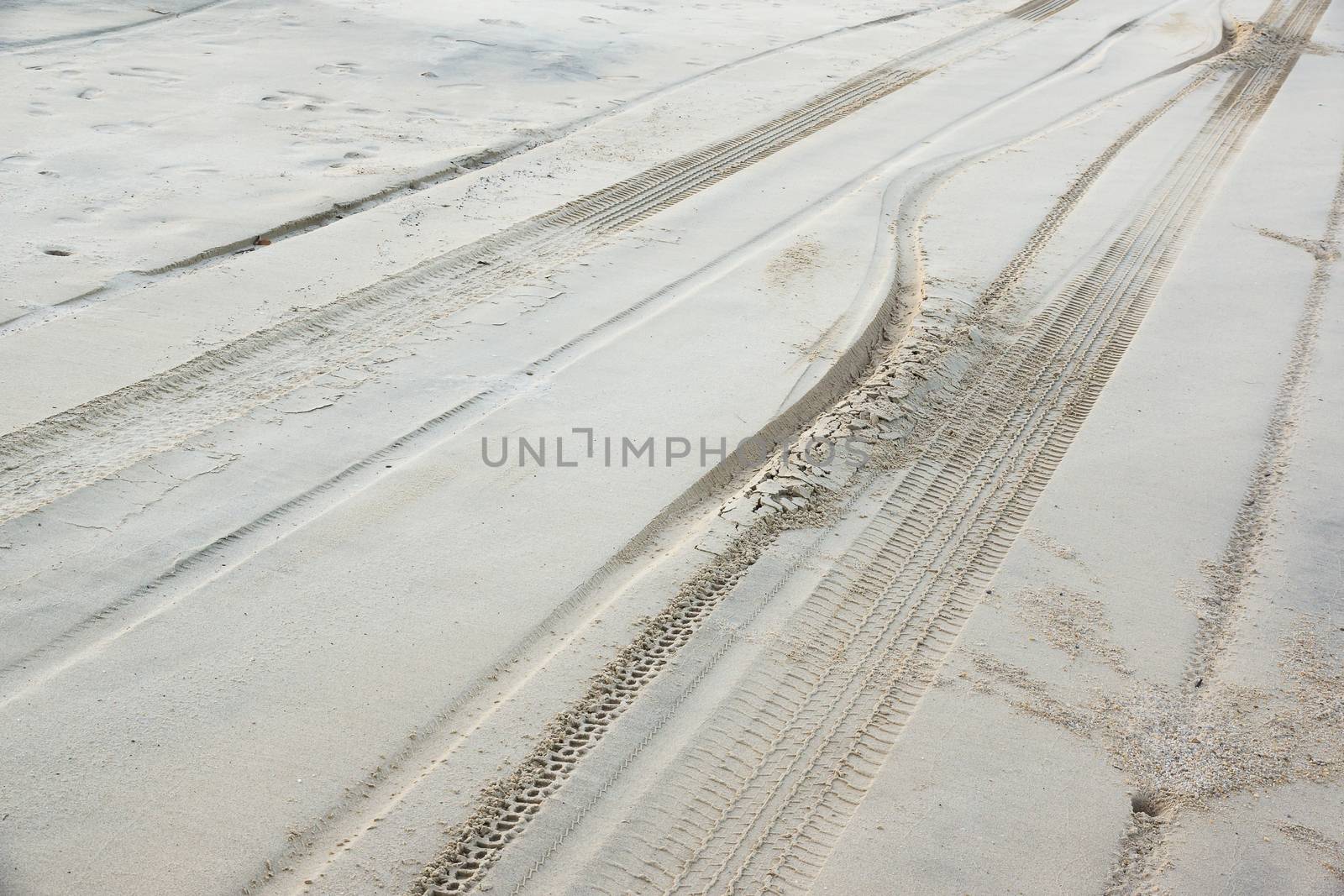 traces of tires traveling through the sand