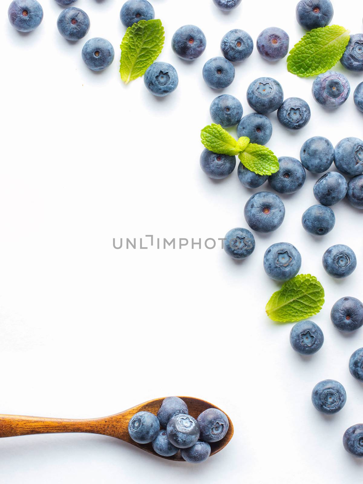 Blueberries isolated on white background. Blueberry border design. Ripe and juicy fresh picked bilberries close up. Copyspace. Top view or flat lay