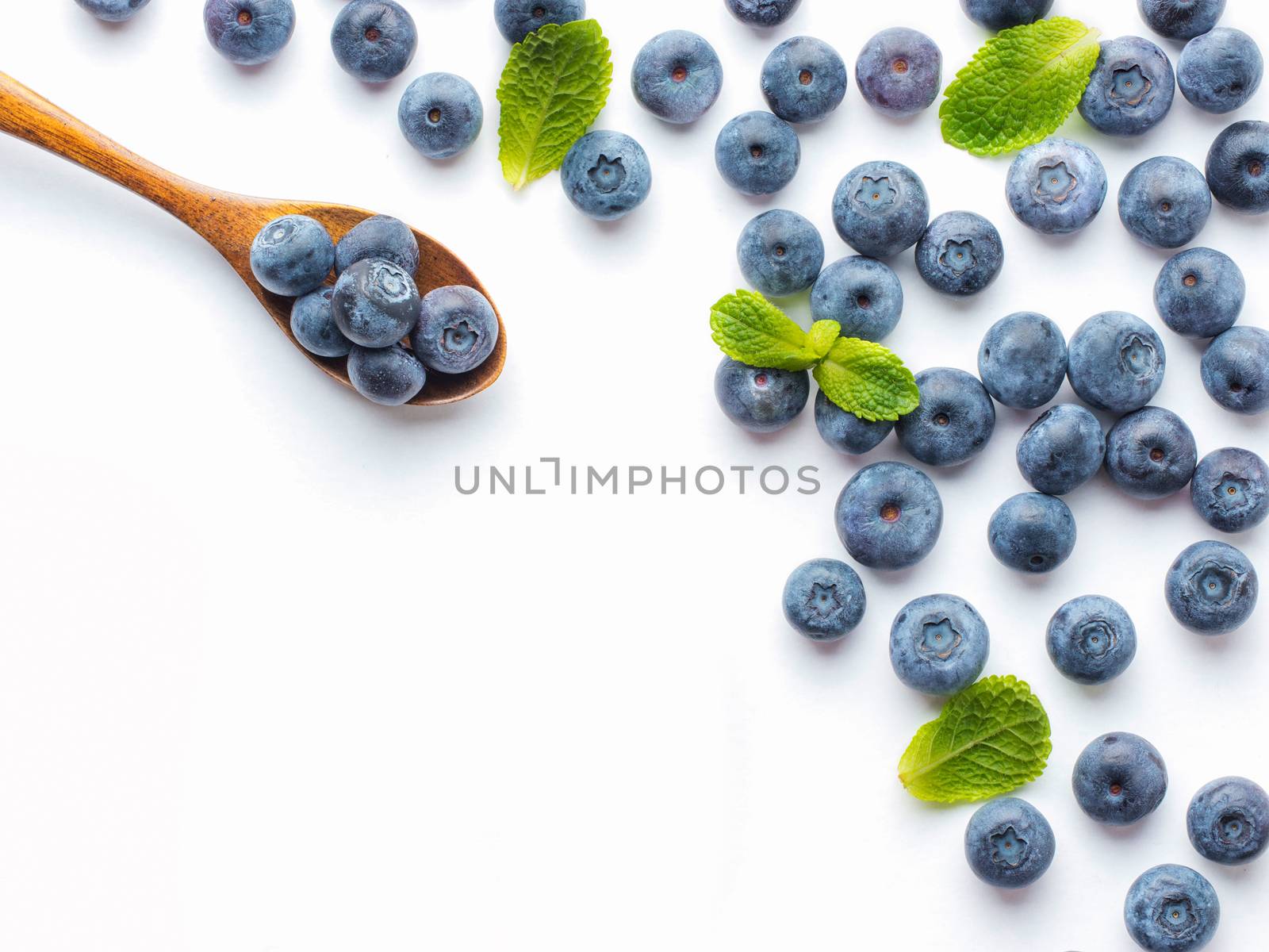 Blueberries isolated on white background. Blueberry border design. Ripe and juicy fresh picked bilberries close up. Copyspace. Top view or flat lay