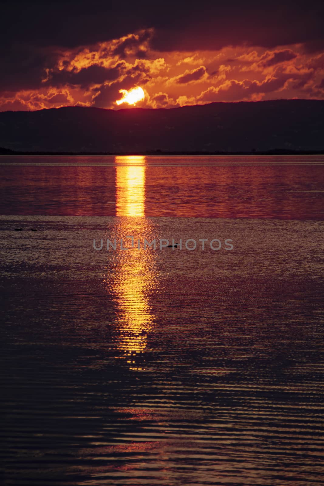 Sunset and reflections on the lagoon in autumn. Calm and peaceful.