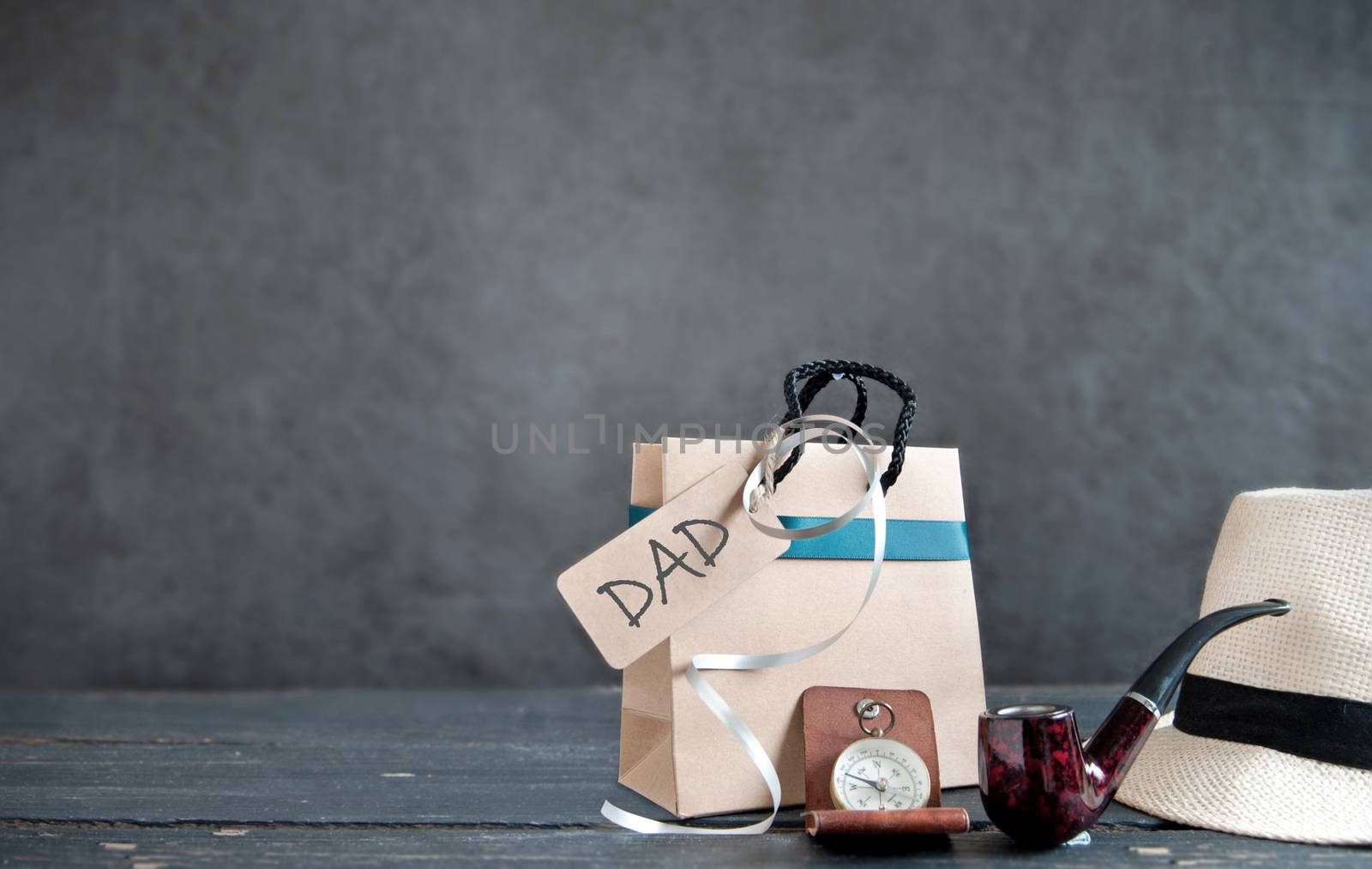 Gift bag with fathers day greting with a hat, pipe and compass