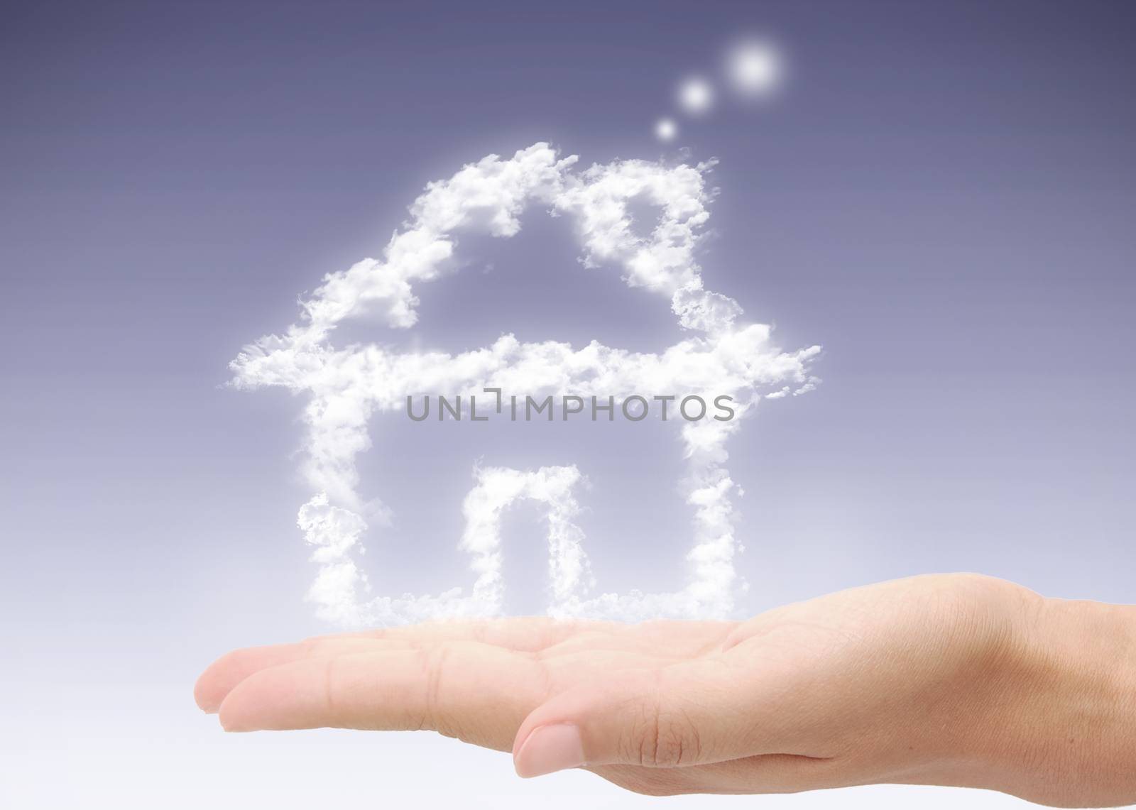 Hand holding dream home by unikpix