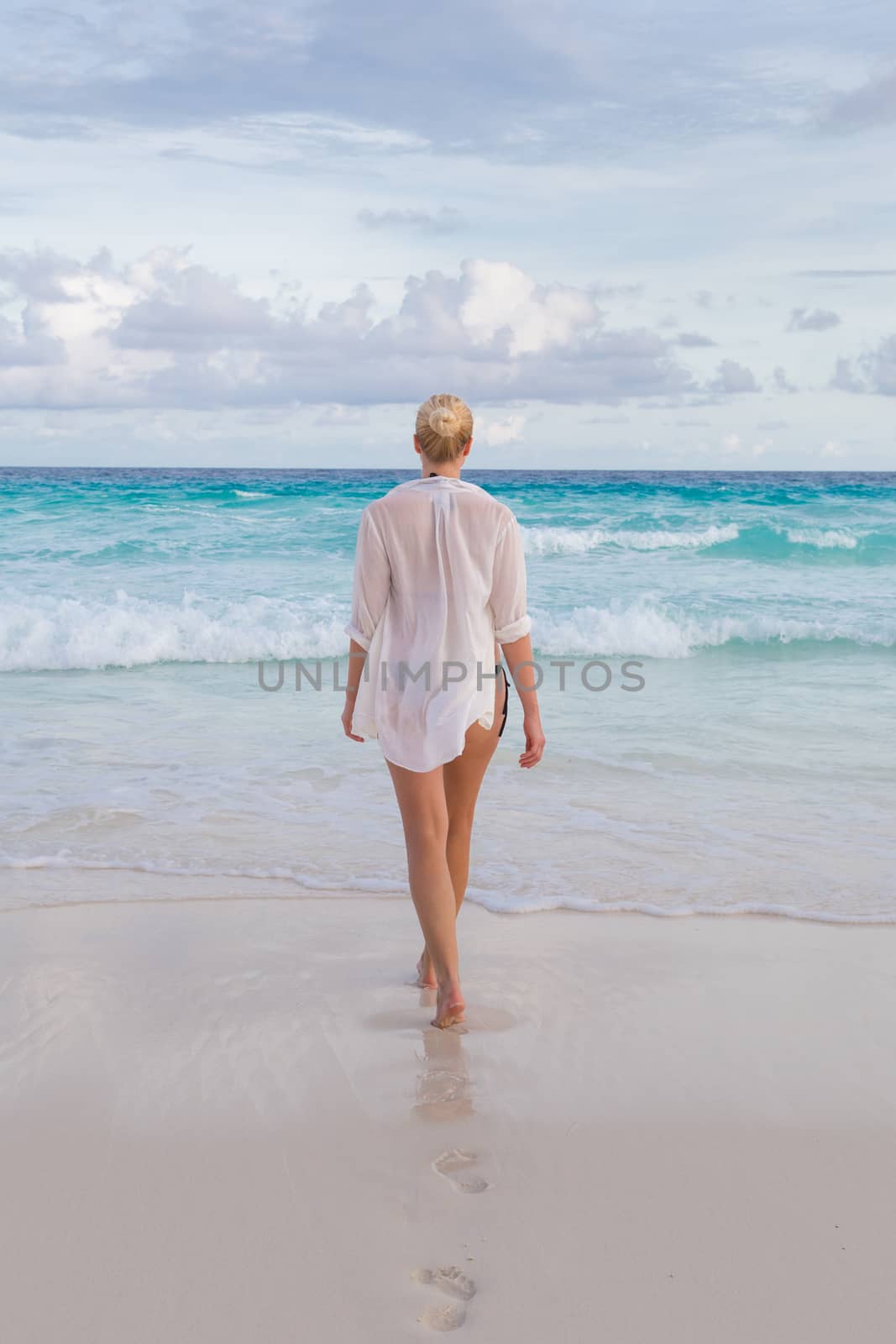 Woman on summer vacations at tropical beach of Mahe Island, Seychelles. by kasto