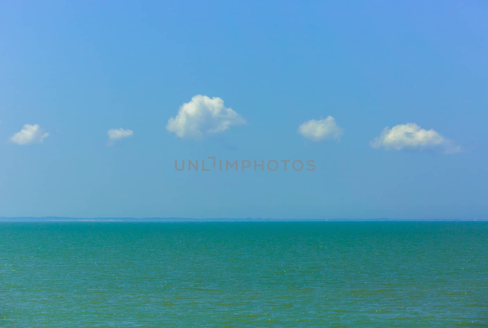 Nature background, clear water and blue cloudy sky.