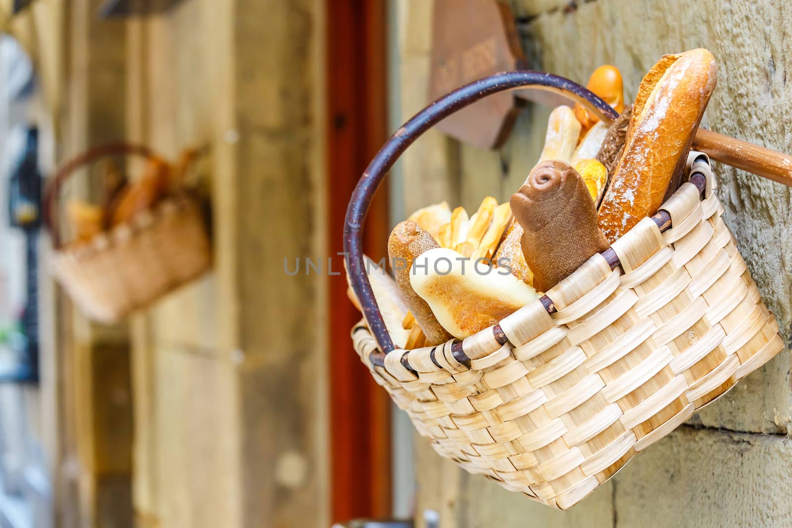 Fresh bread in the basket in front a bakery shop