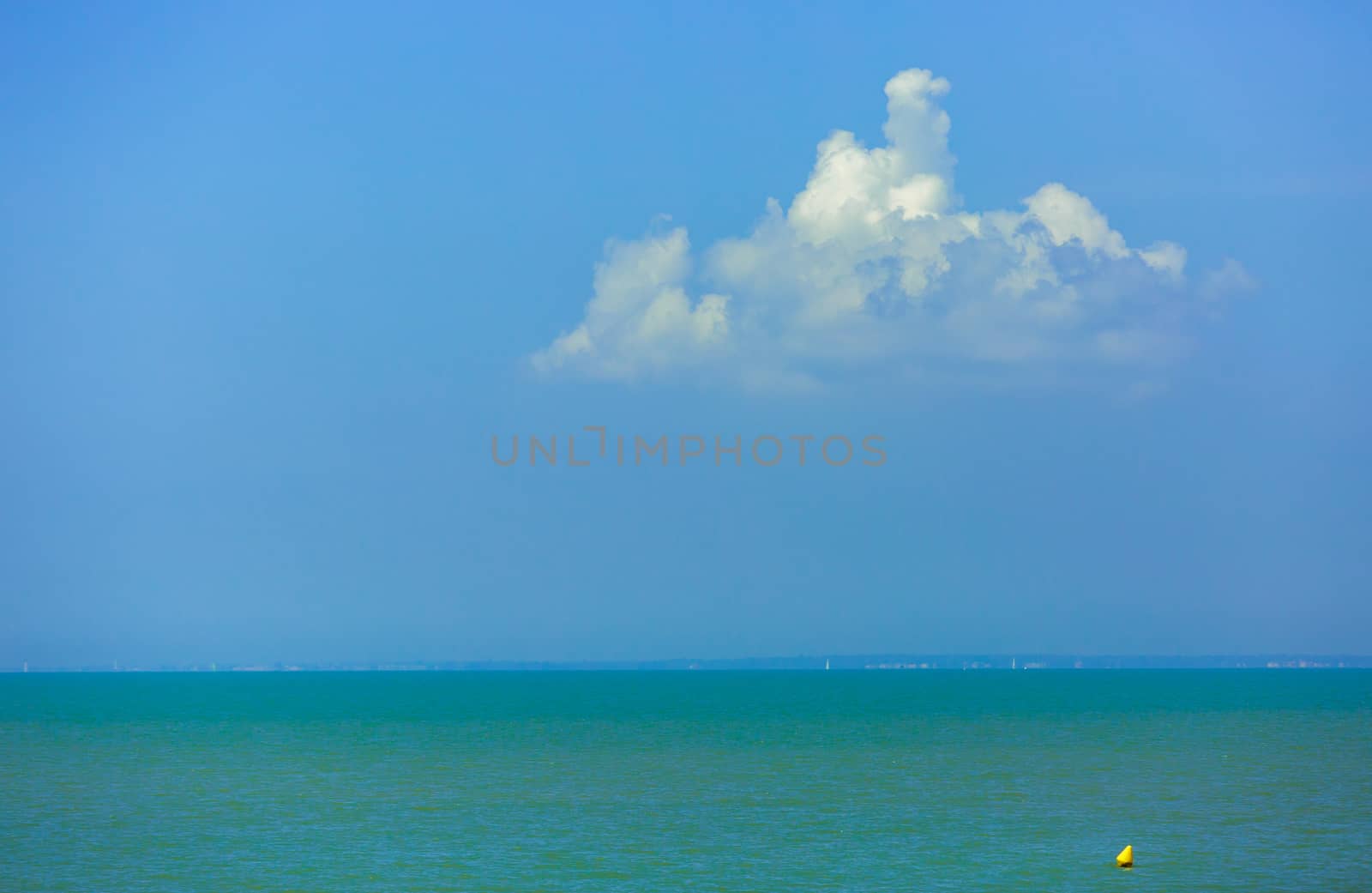 Nature background, clear water and blue cloudy sky.