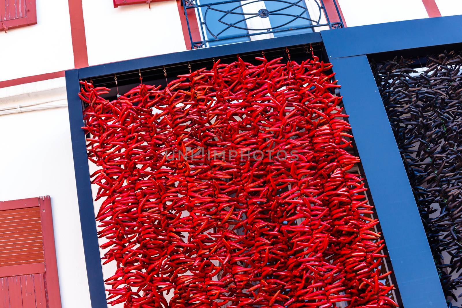 A typical basque frontage with bunches of drying red pappers.