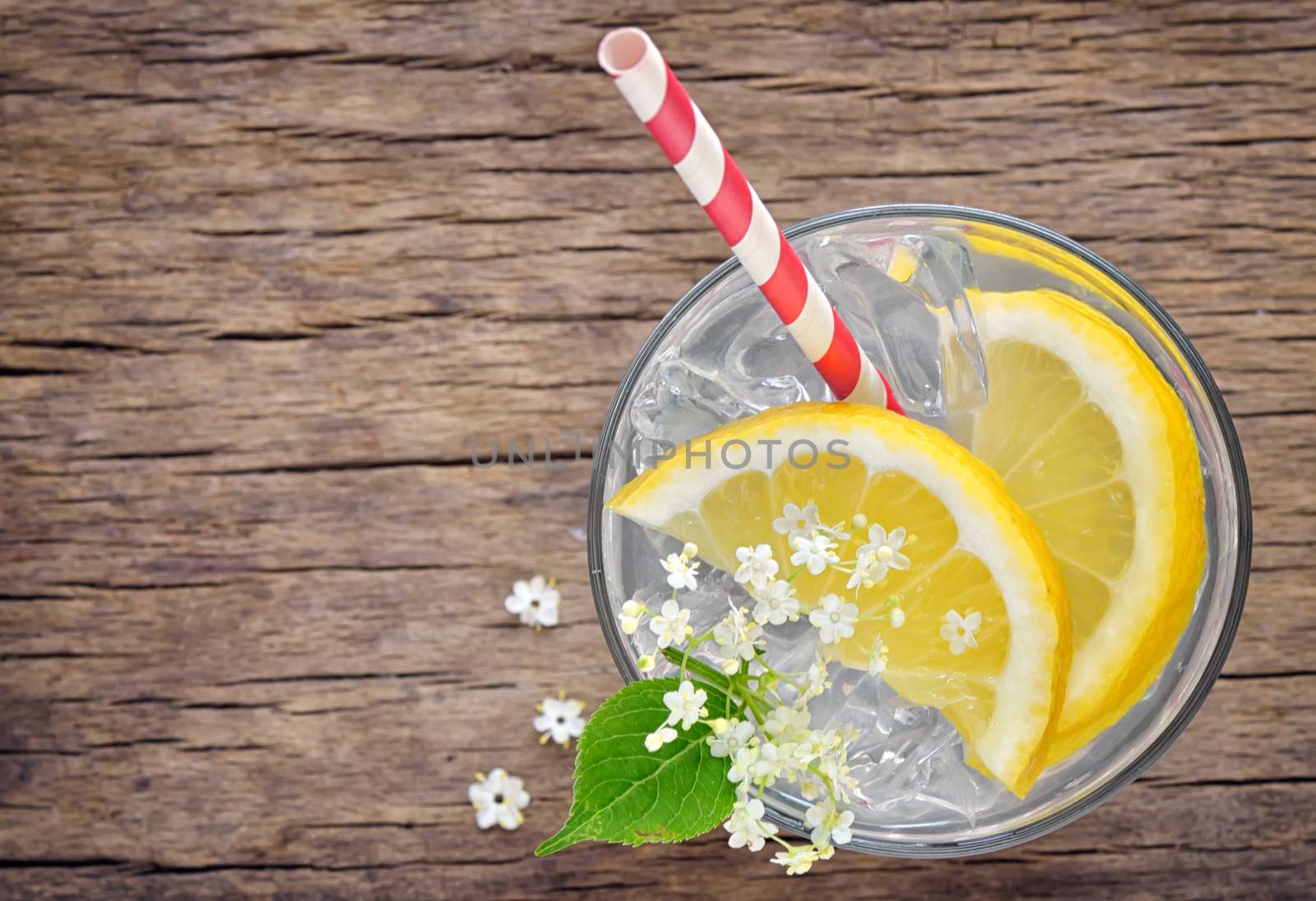 Elder lemonade with ice on old table wood