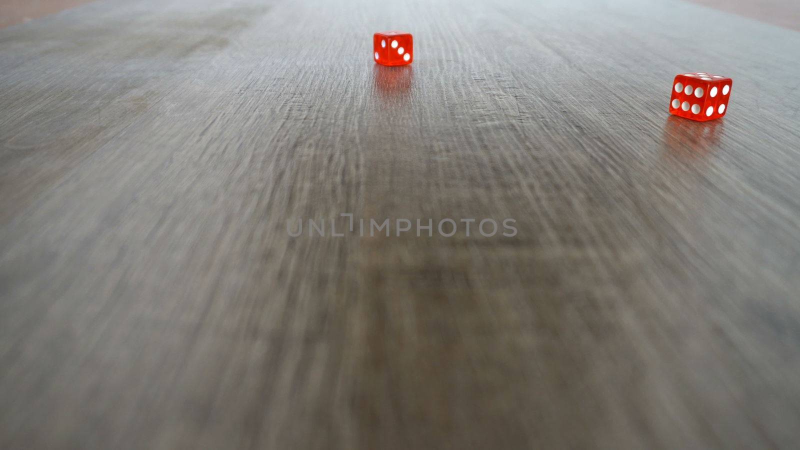 Throwing red dice on a grey background in the casino. Slow motion by nolimit046