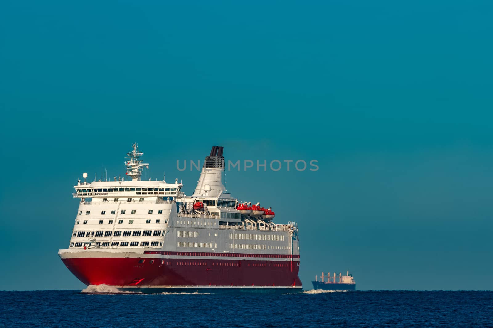 Red cruise liner. Large passenger ferry underway