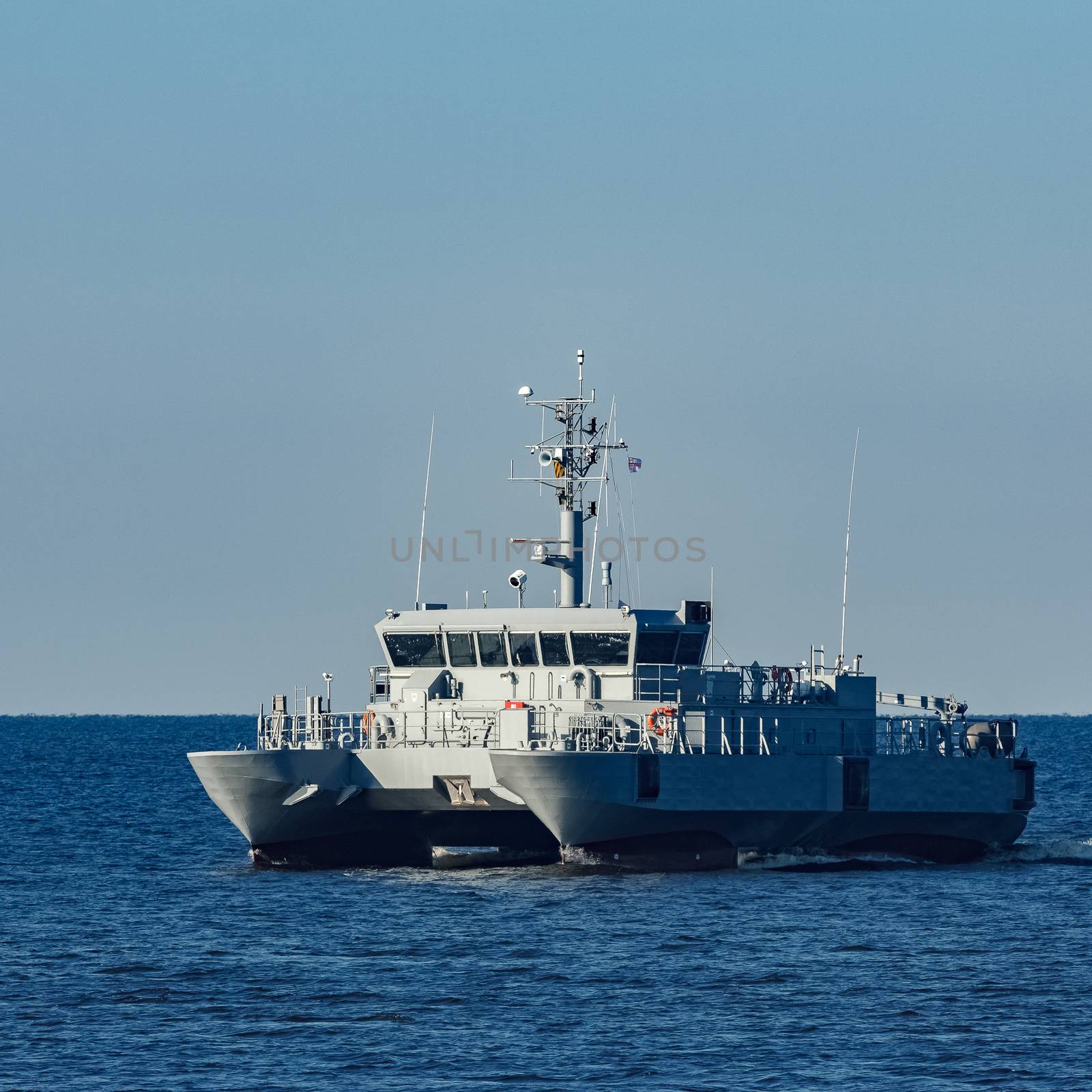 Small grey military ship moving from Baltic sea