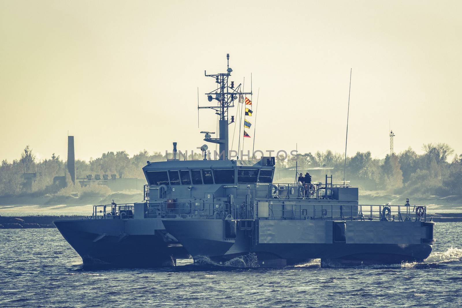 Small grey military ship moving from Baltic sea