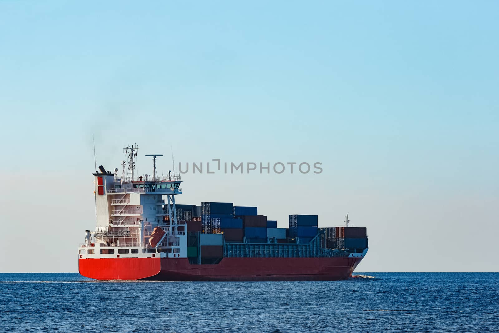 Red container ship sailing to the Baltic sea