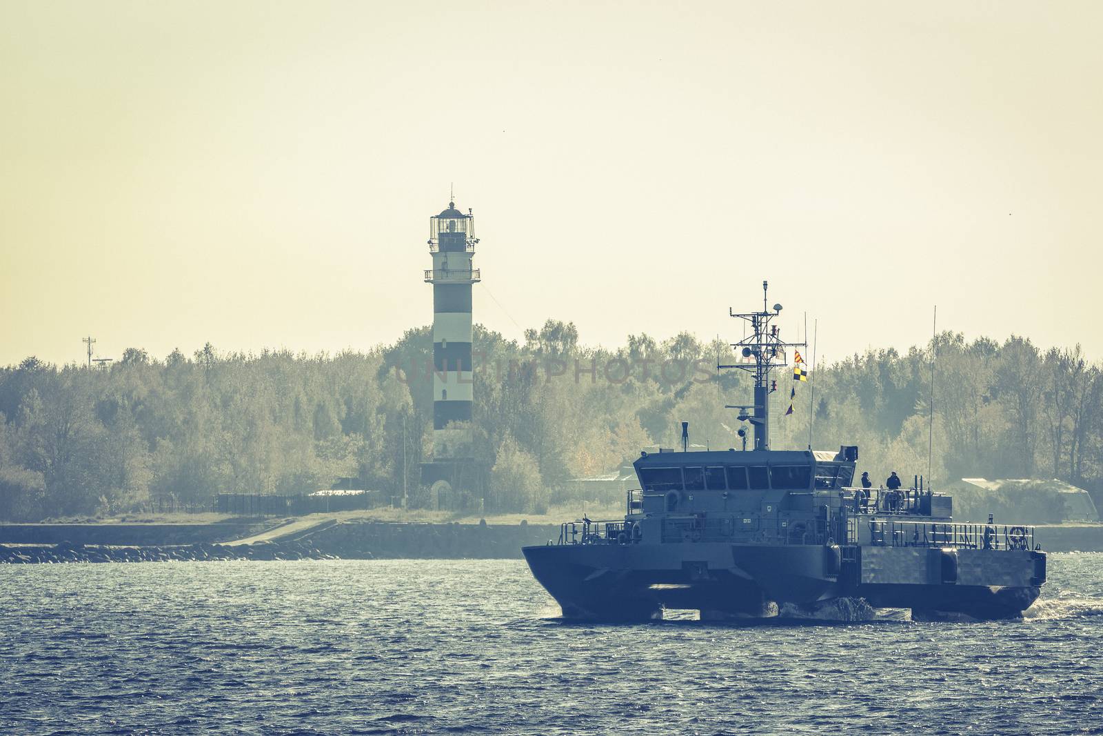 Small grey military ship moving from Baltic sea