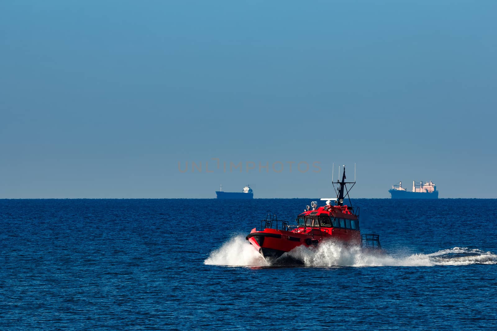 Red pilot ship moving from the Baltic sea