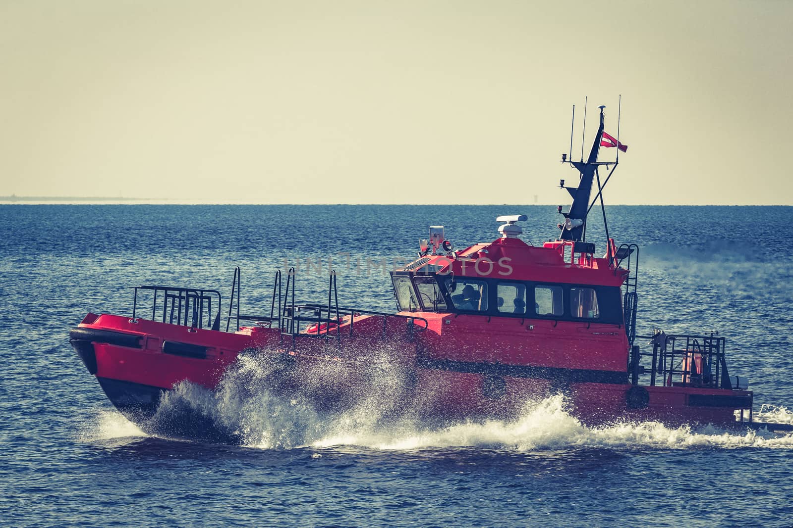 Red pilot ship moving from the Baltic sea