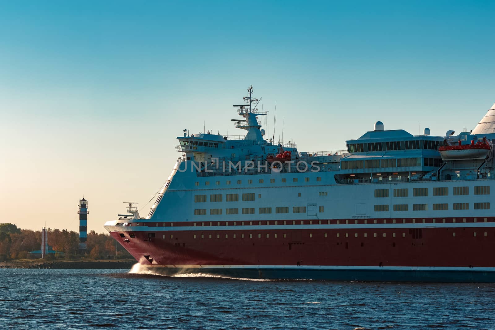 Red cruise liner. Large passenger ferry underway