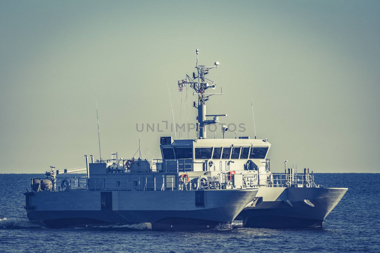 Small grey military ship moving from Baltic sea