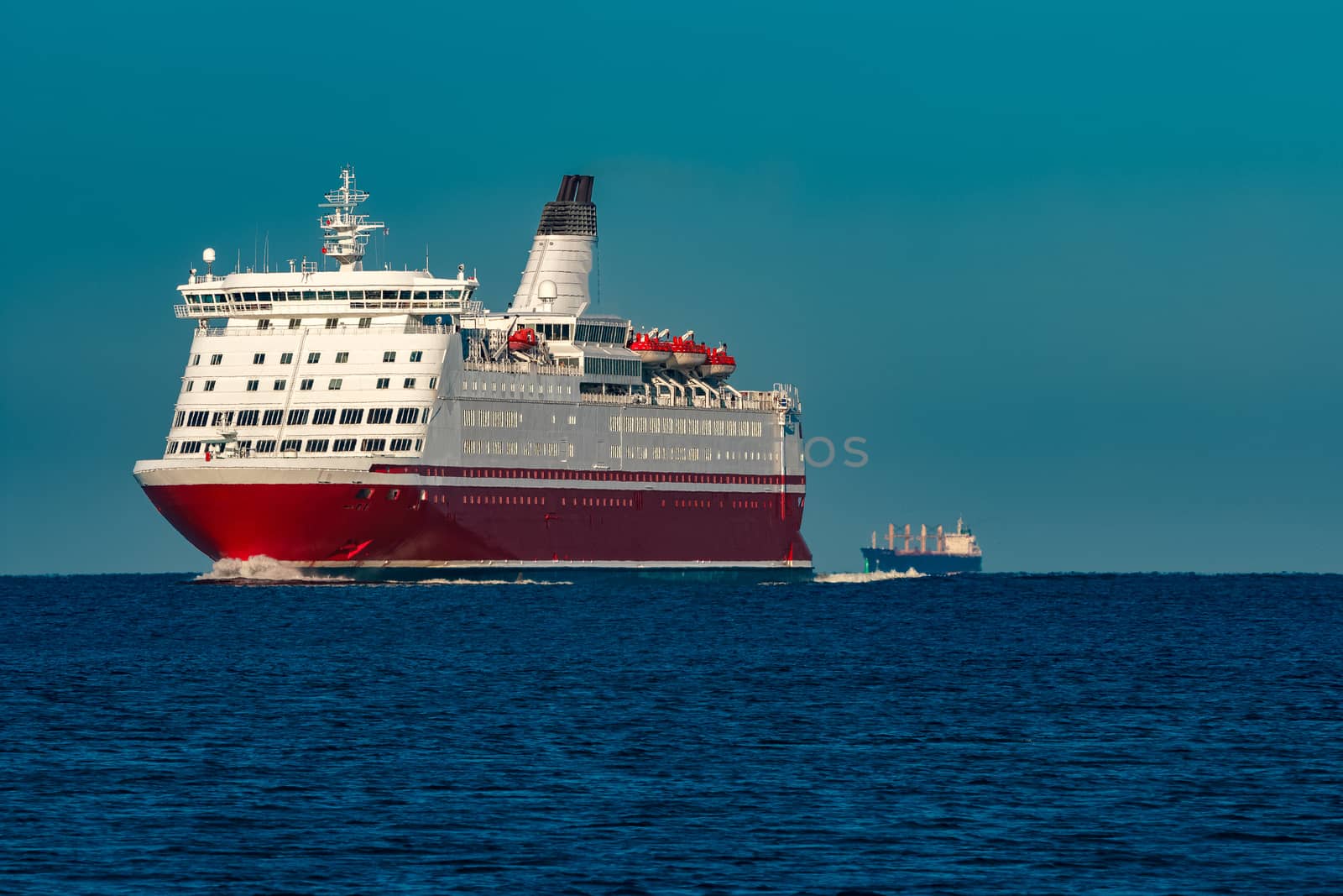 Red cruise liner. Large passenger ferry underway