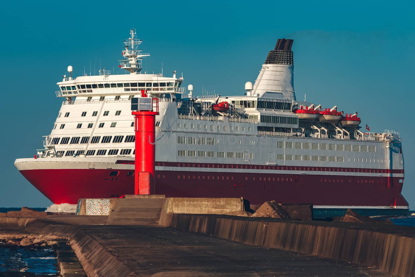 Red cruise liner. Large passenger ferry underway