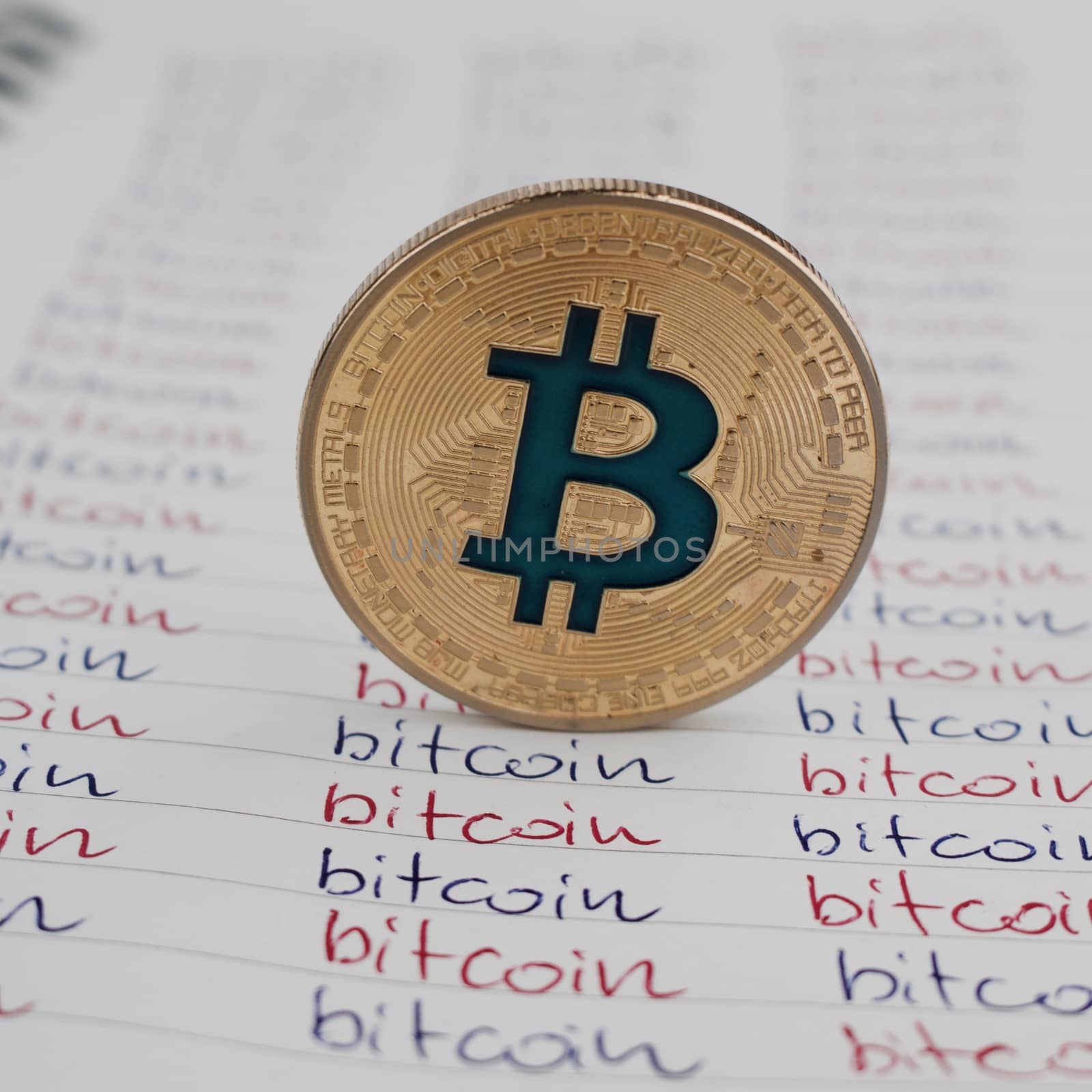 Cryptocurrency physical gold bitcoin coin in notebook.