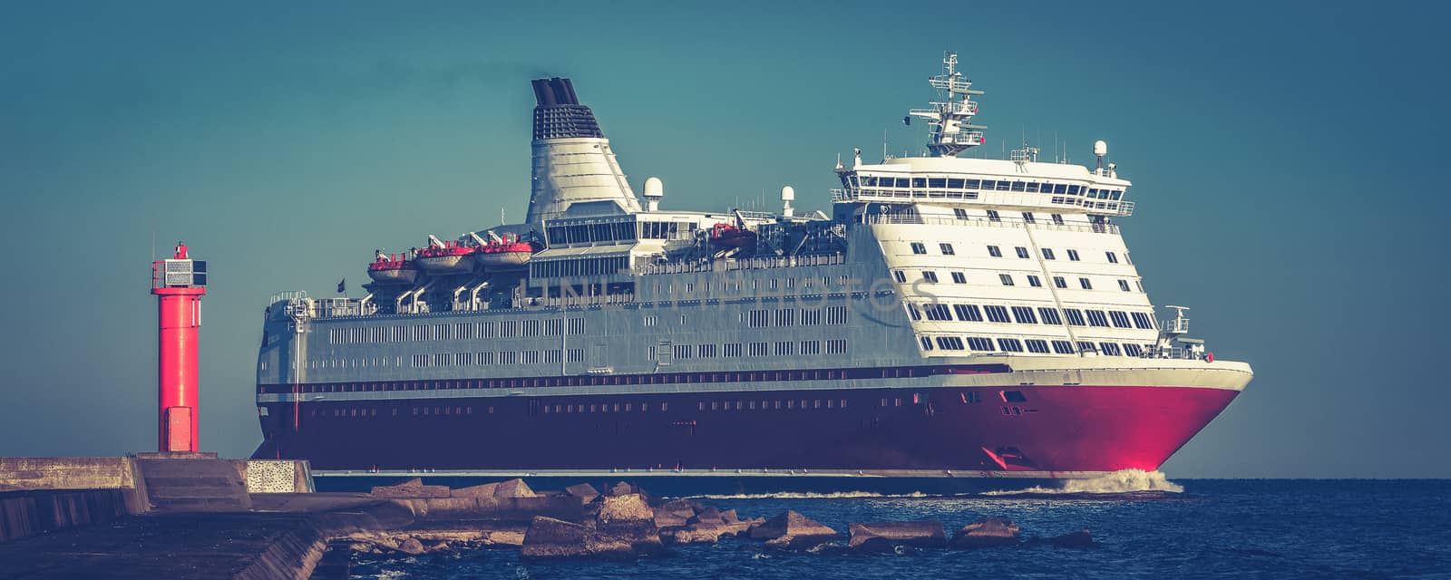Red cruise liner. Large passenger ferry underway