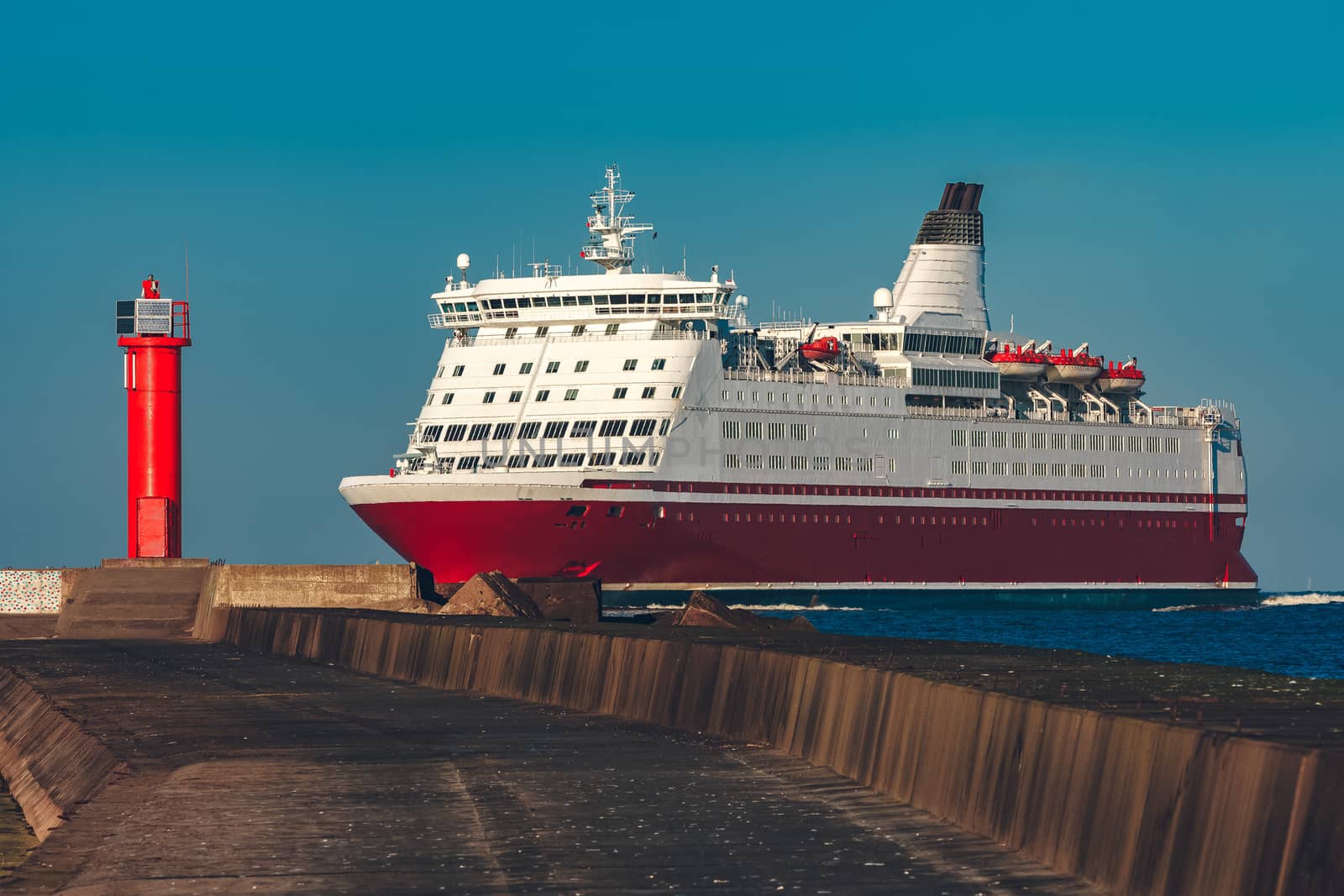 Red cruise liner. Large passenger ferry underway