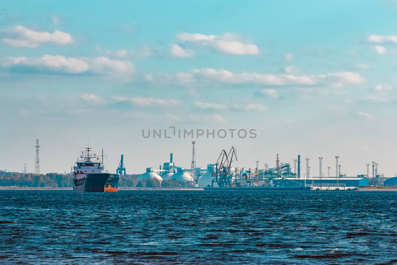 Blue cargo ship moving to the cargo port