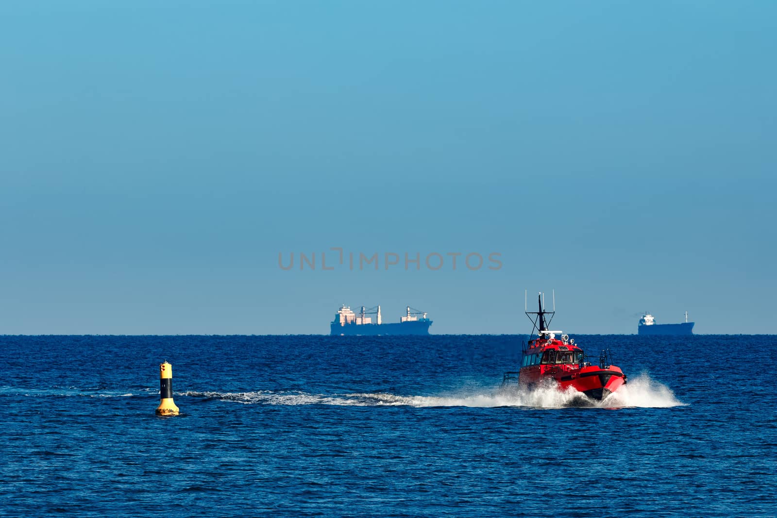 Red pilot ship moving from the Baltic sea