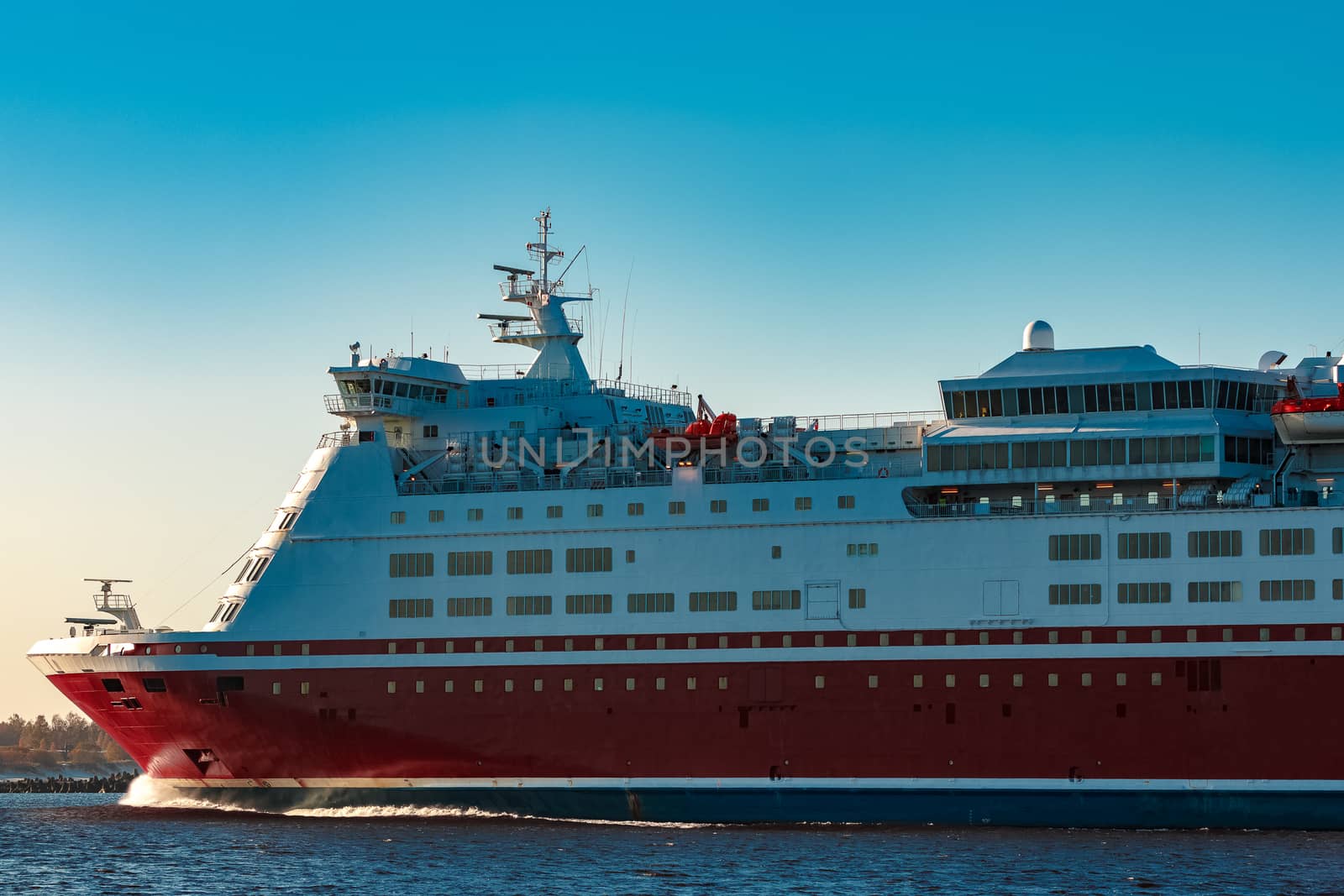 Red cruise liner. Large passenger ferry underway