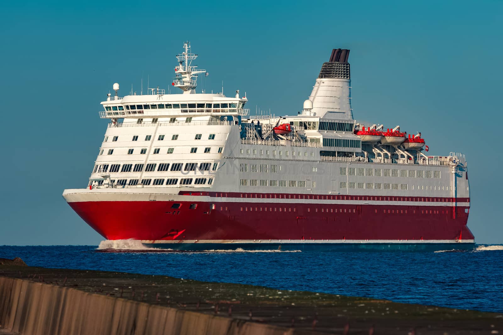 Red cruise liner. Large passenger ferry underway