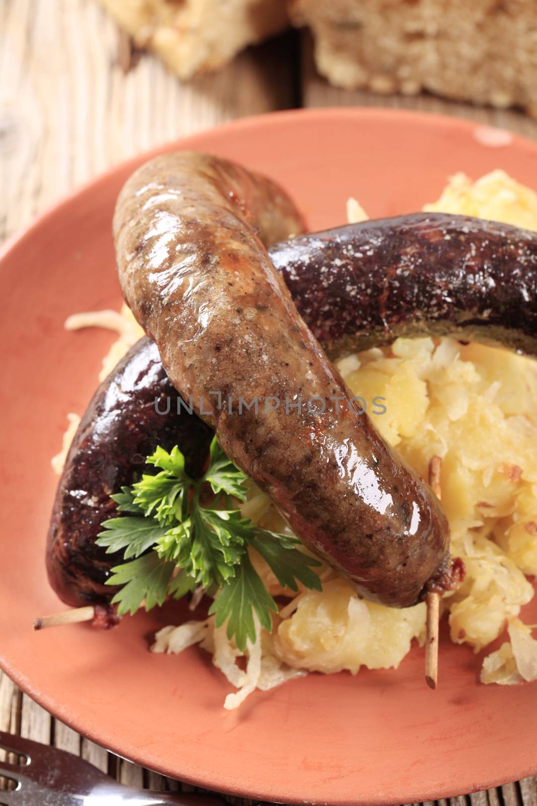 Blood sausage and white pudding with sauerkraut and potatoes