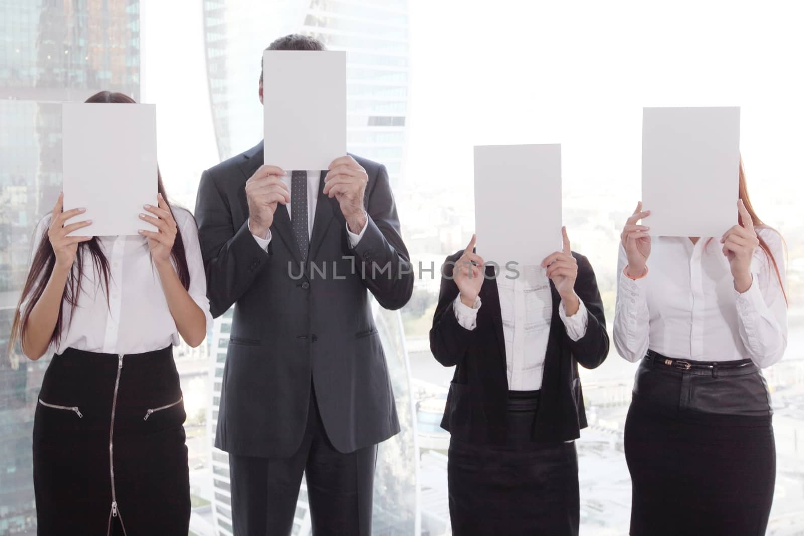 Business group holding white papers by ALotOfPeople