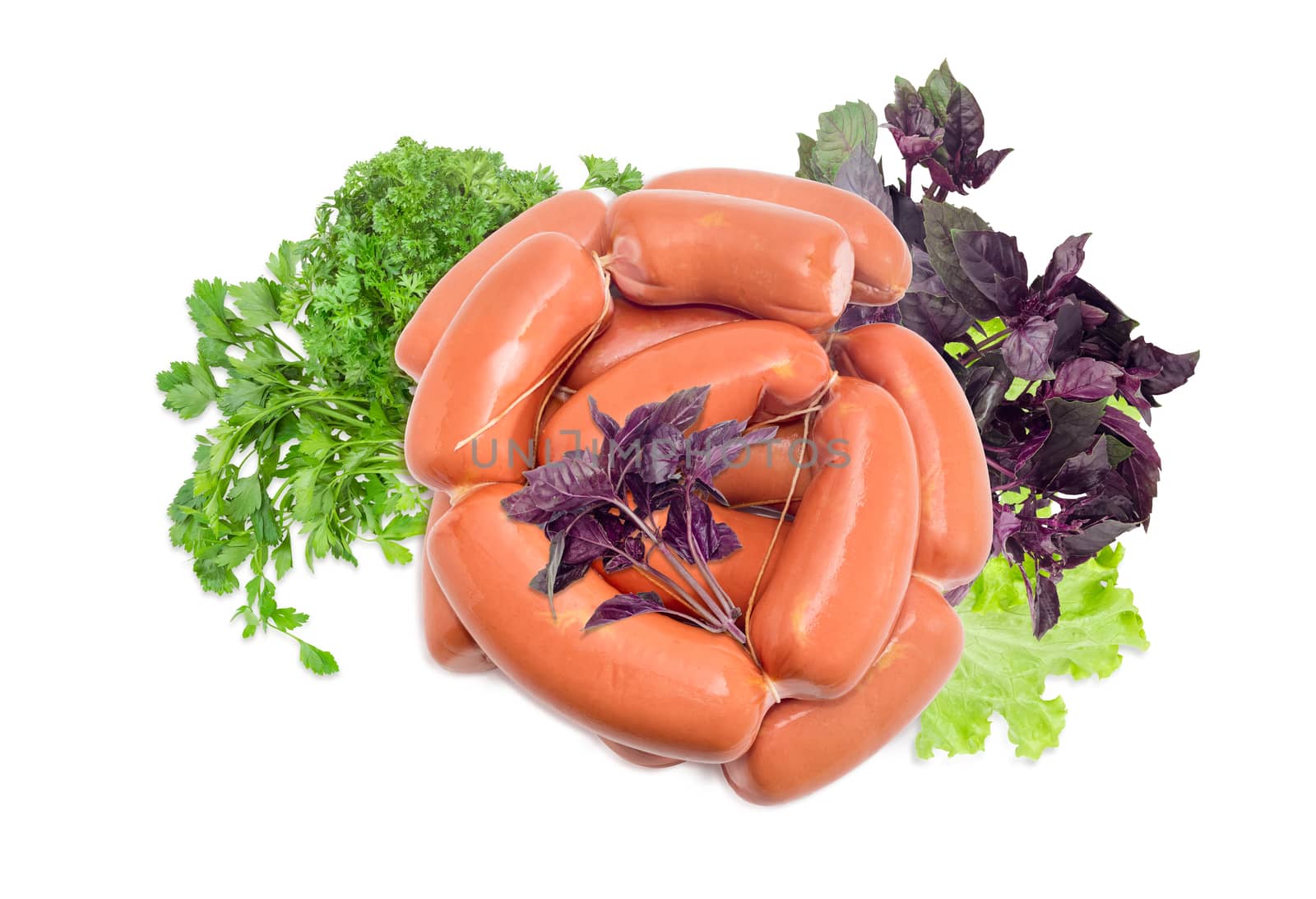 Pile of the uncooked wieners bound by twine and leaves of purple basil, lettuce, and parsley on a light background

