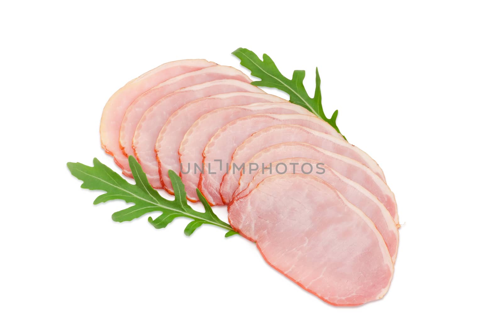 Sliced boiled smoked pork loin with arugula leaves on a light background
