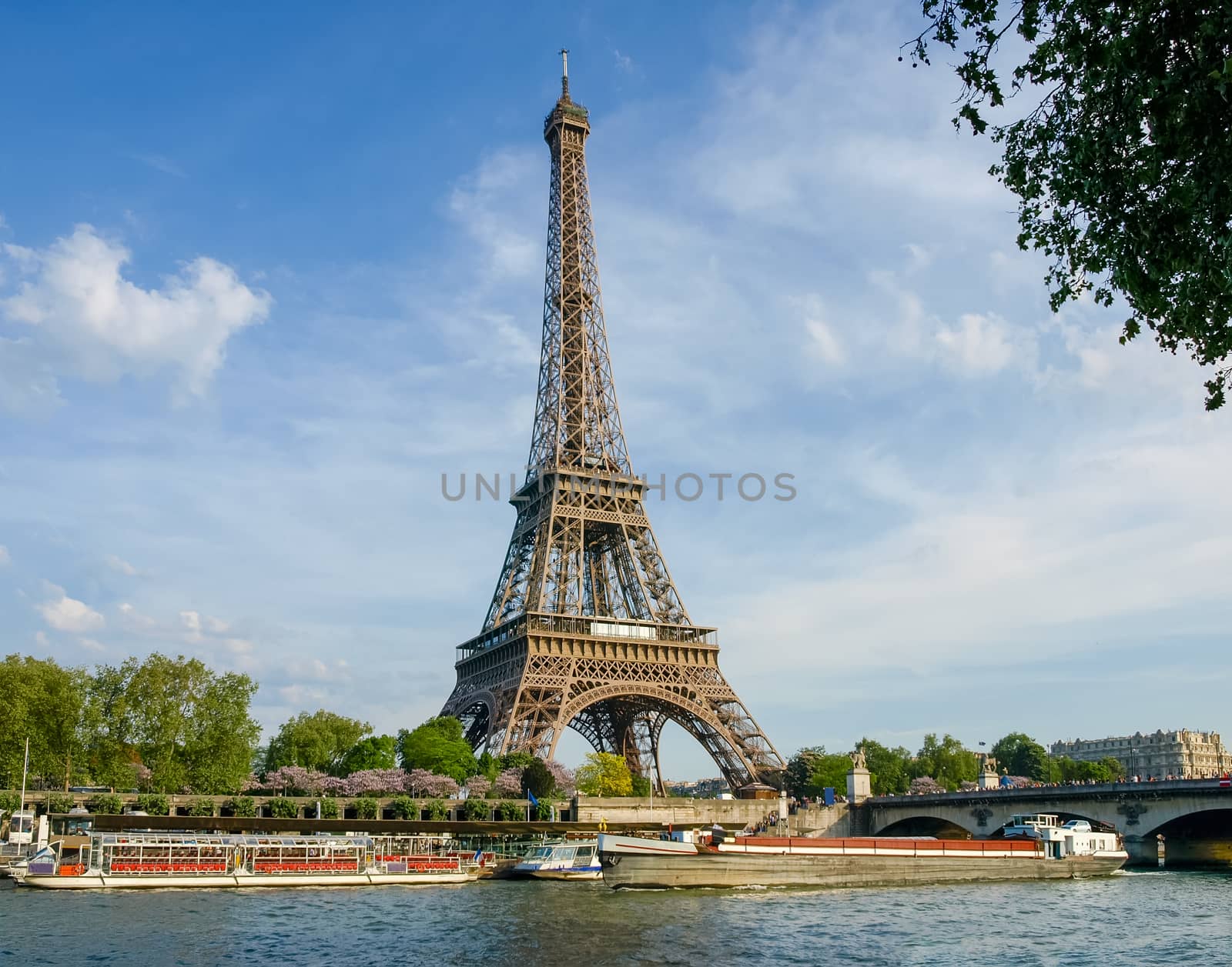 Eiffel Tower with river Seine on the foreground against of the sky in springtime in Paris, France.
