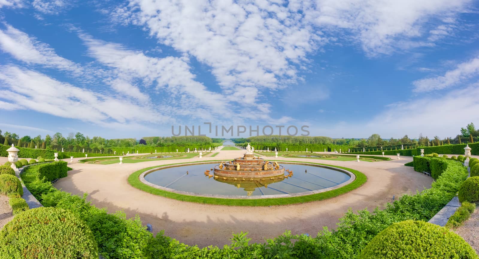 Panorama of the Gardens of Versailles with the Latona Fountain in the foreground and the Grand Canal in the background on a spring morning, France
