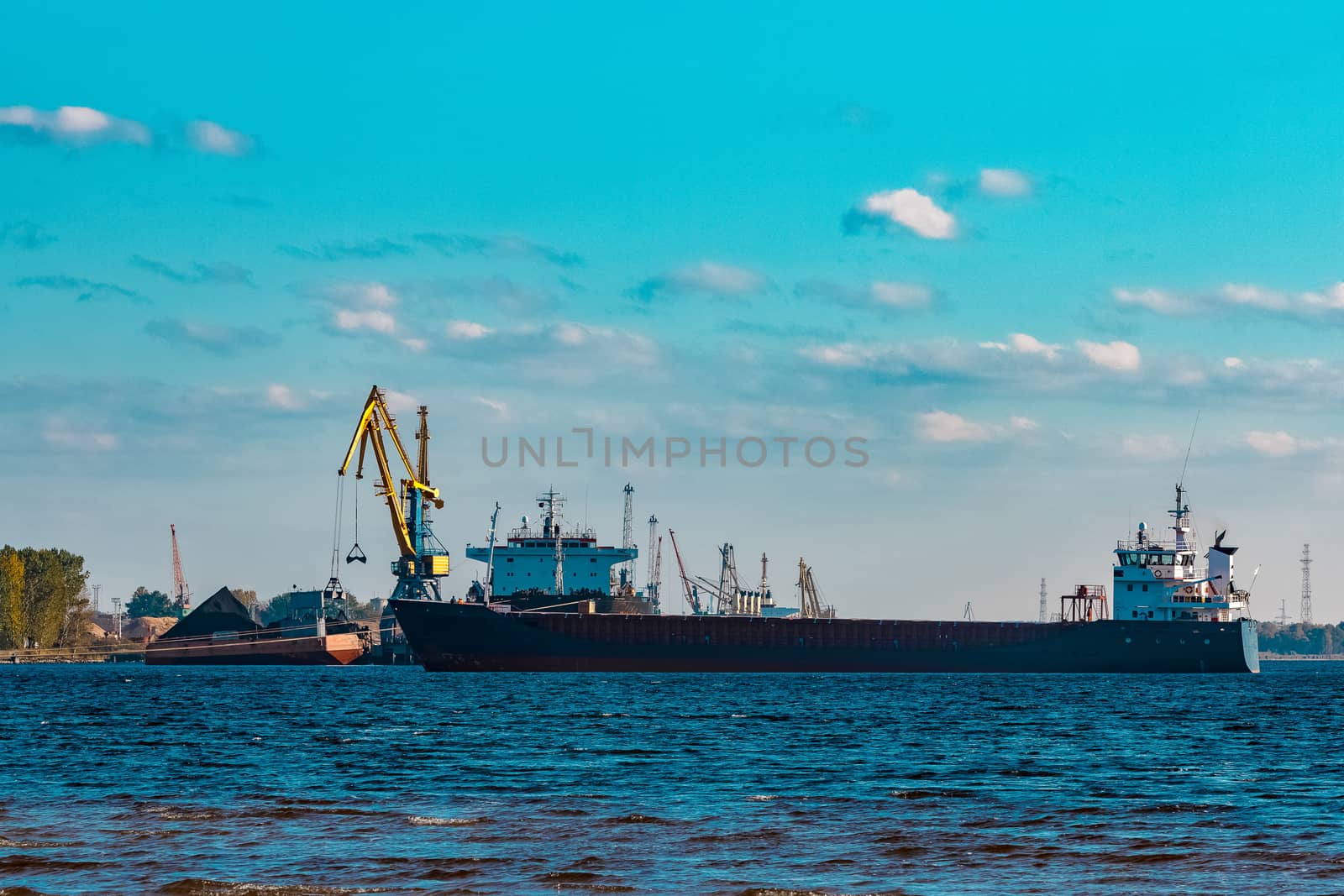 Blue cargo ship moving to the cargo port