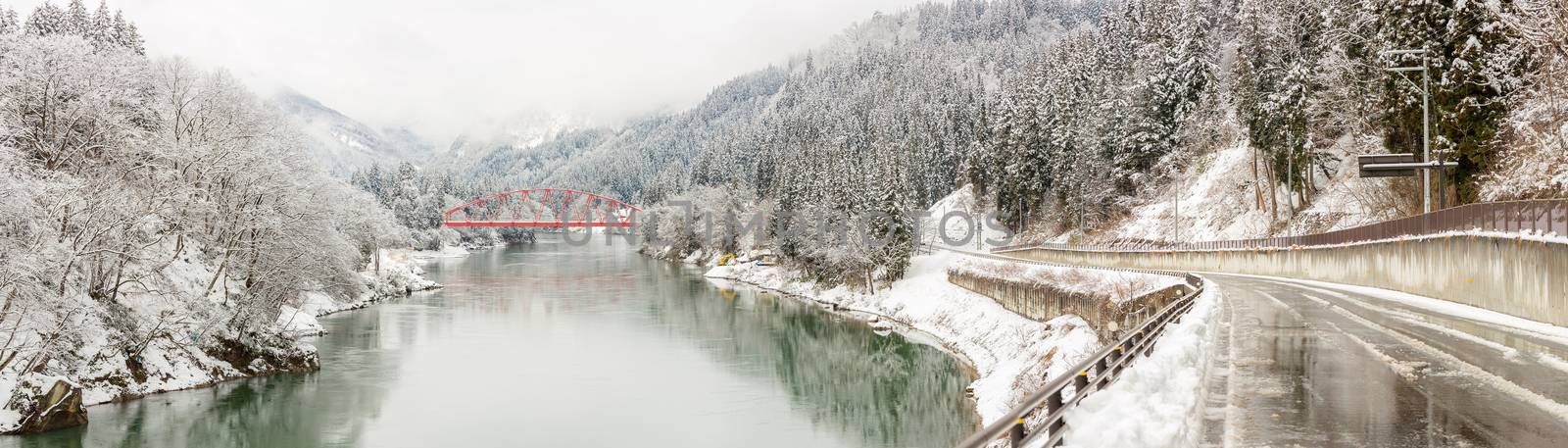 winter landscape with Red Bridge along Tadami River in Fukushima Japan Panorama 