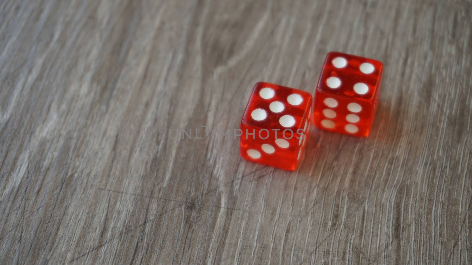 Throwing red dice on a grey background in the casino.