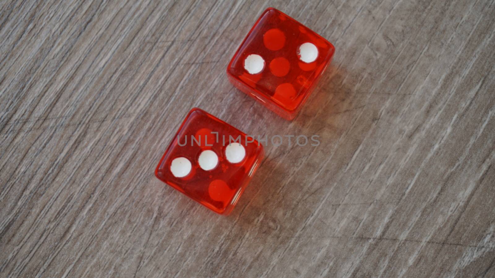 Throwing red dice on a grey background in the casino by nolimit046