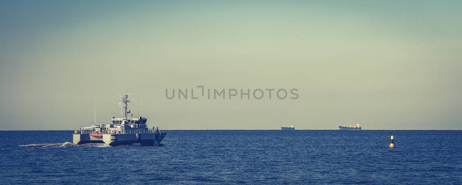 Small grey military ship moving from Baltic sea