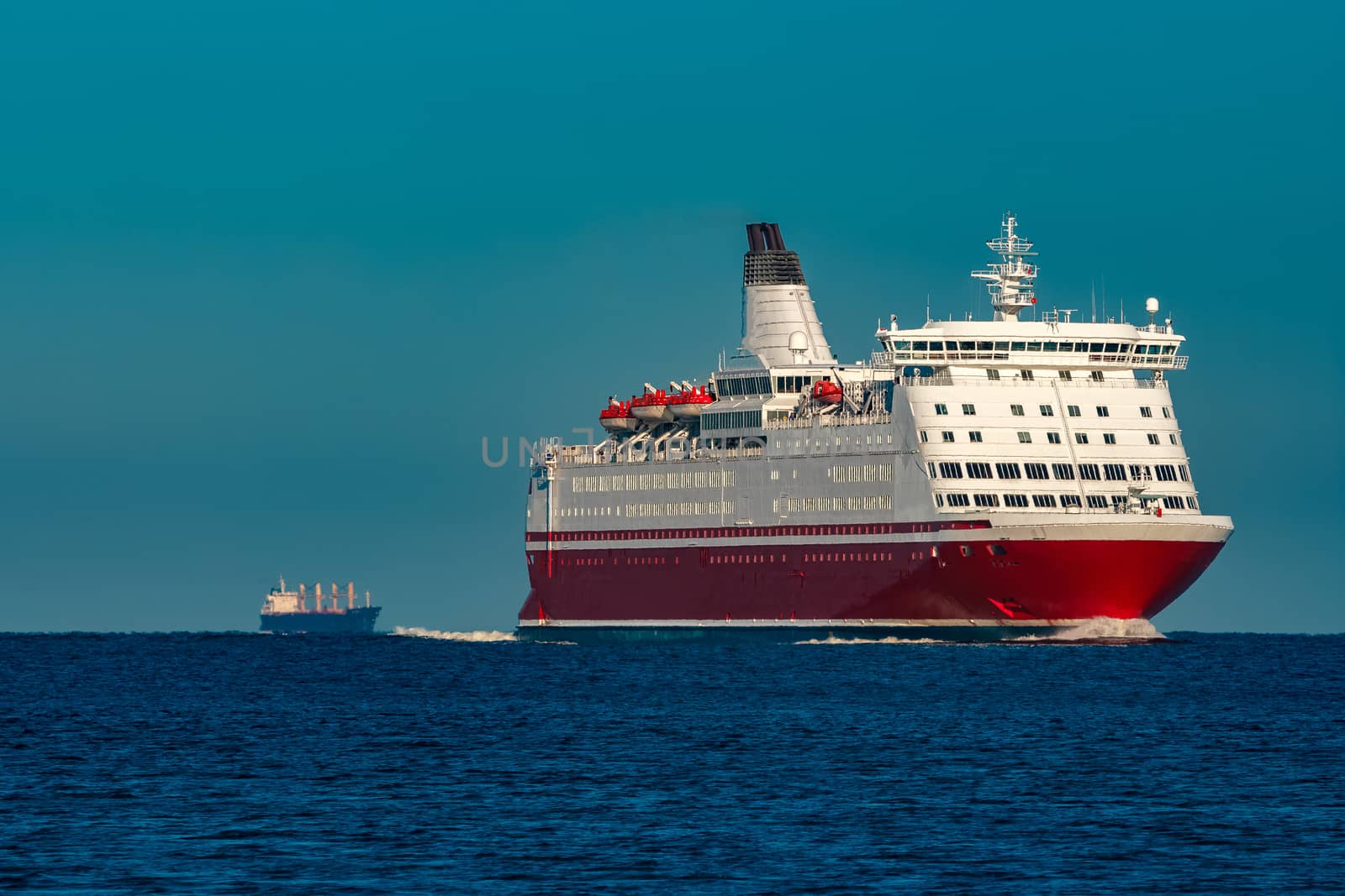Red cruise liner. Large passenger ferry underway