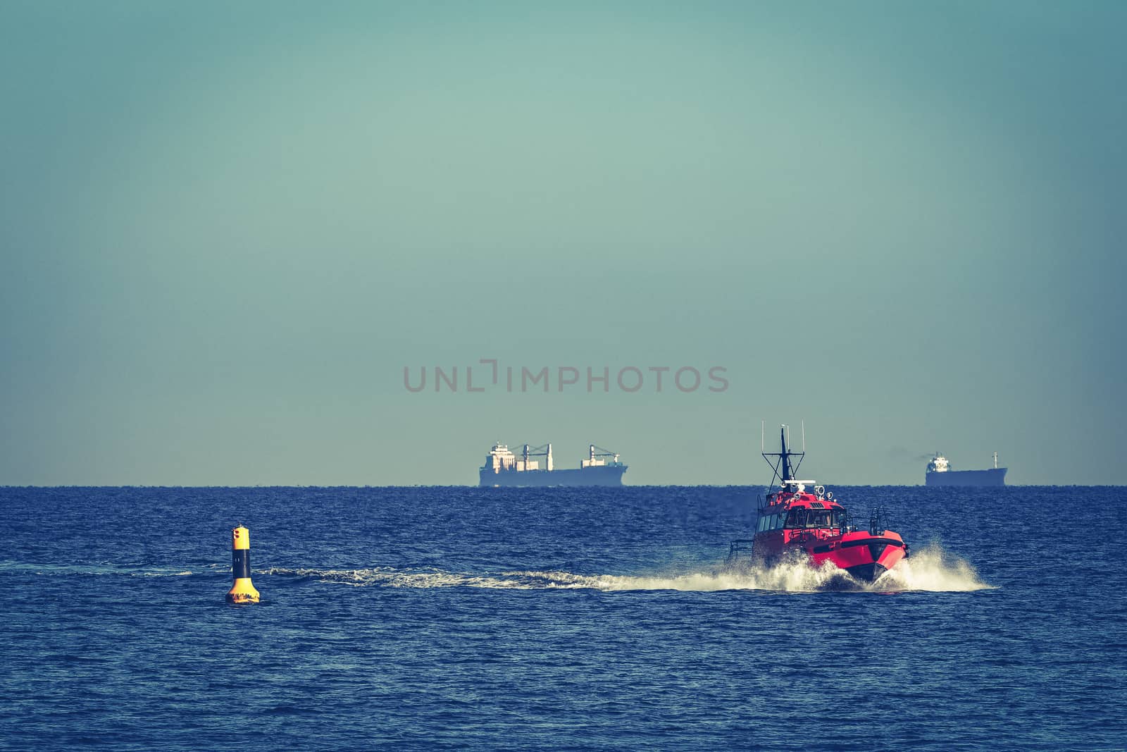 Red pilot ship moving from the Baltic sea