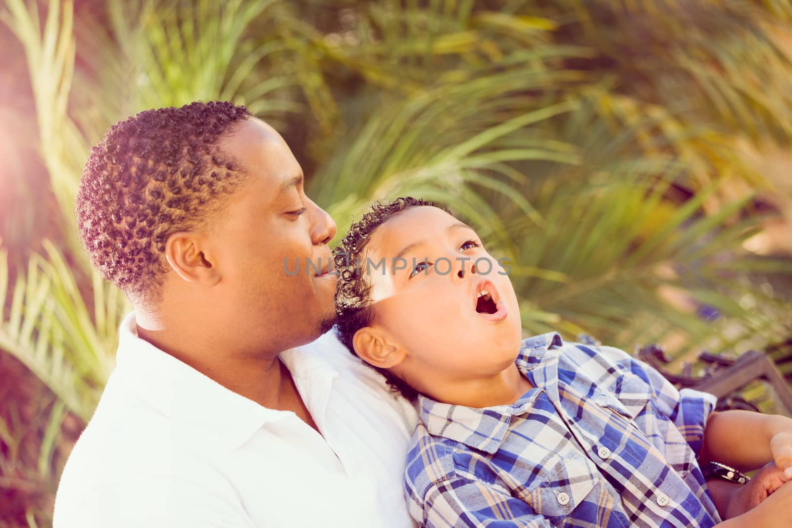 Mixed Race Son and African American Father Playing Outdoors Together.