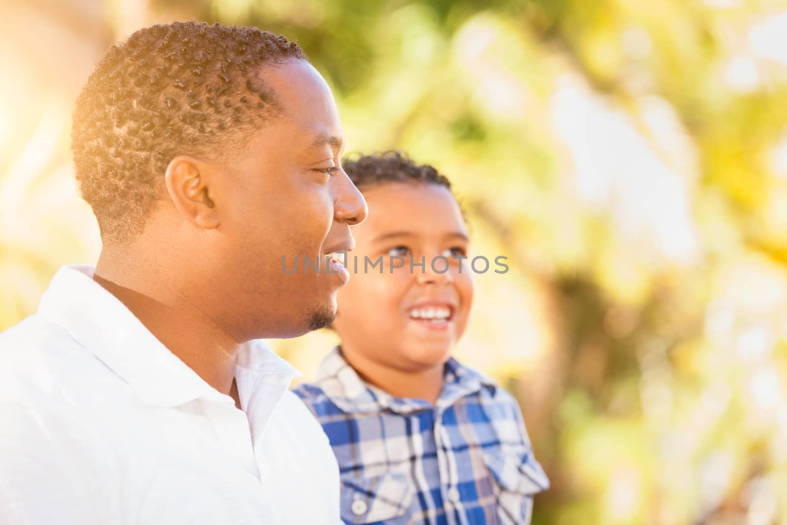 Mixed Race Son and African American Father Playing Outdoors Together. by Feverpitched