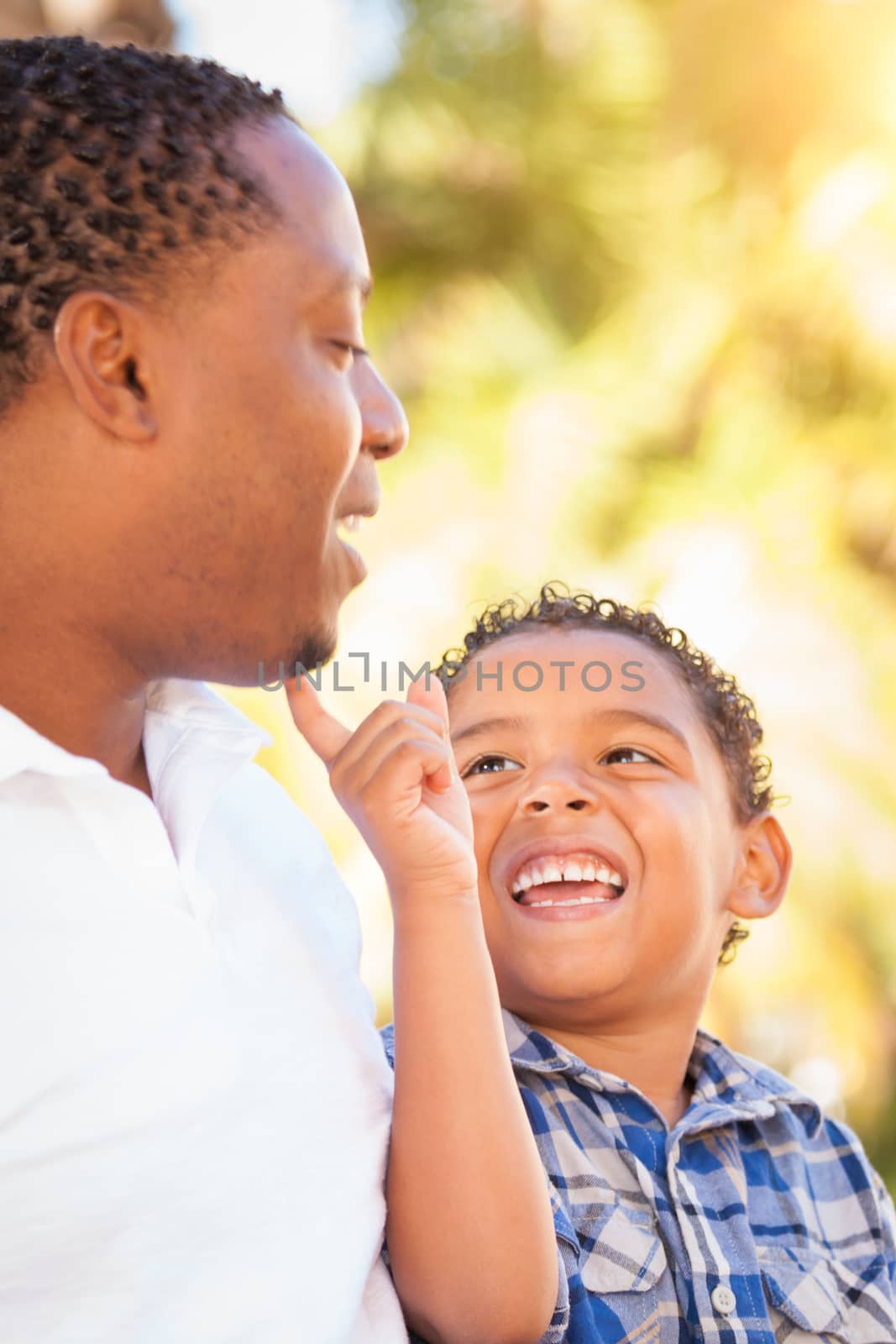 Mixed Race Son and African American Father Playing Outdoors Together.