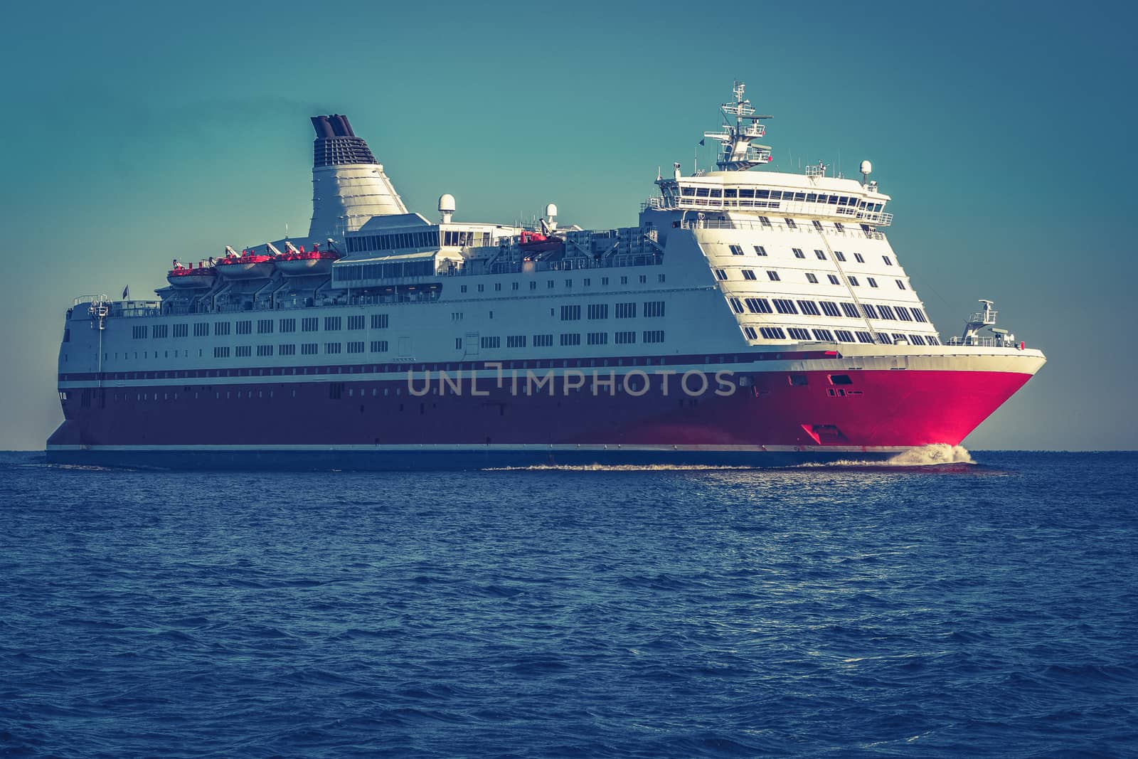 Red cruise liner. Large passenger ferry underway