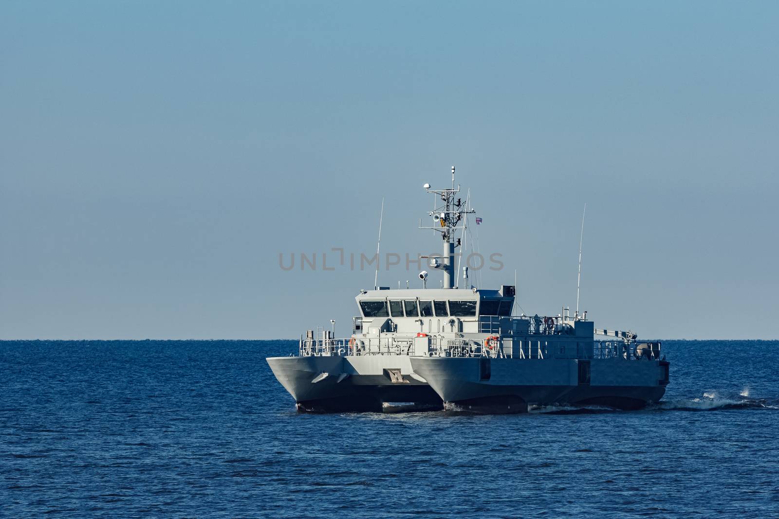 Small grey military ship moving from Baltic sea